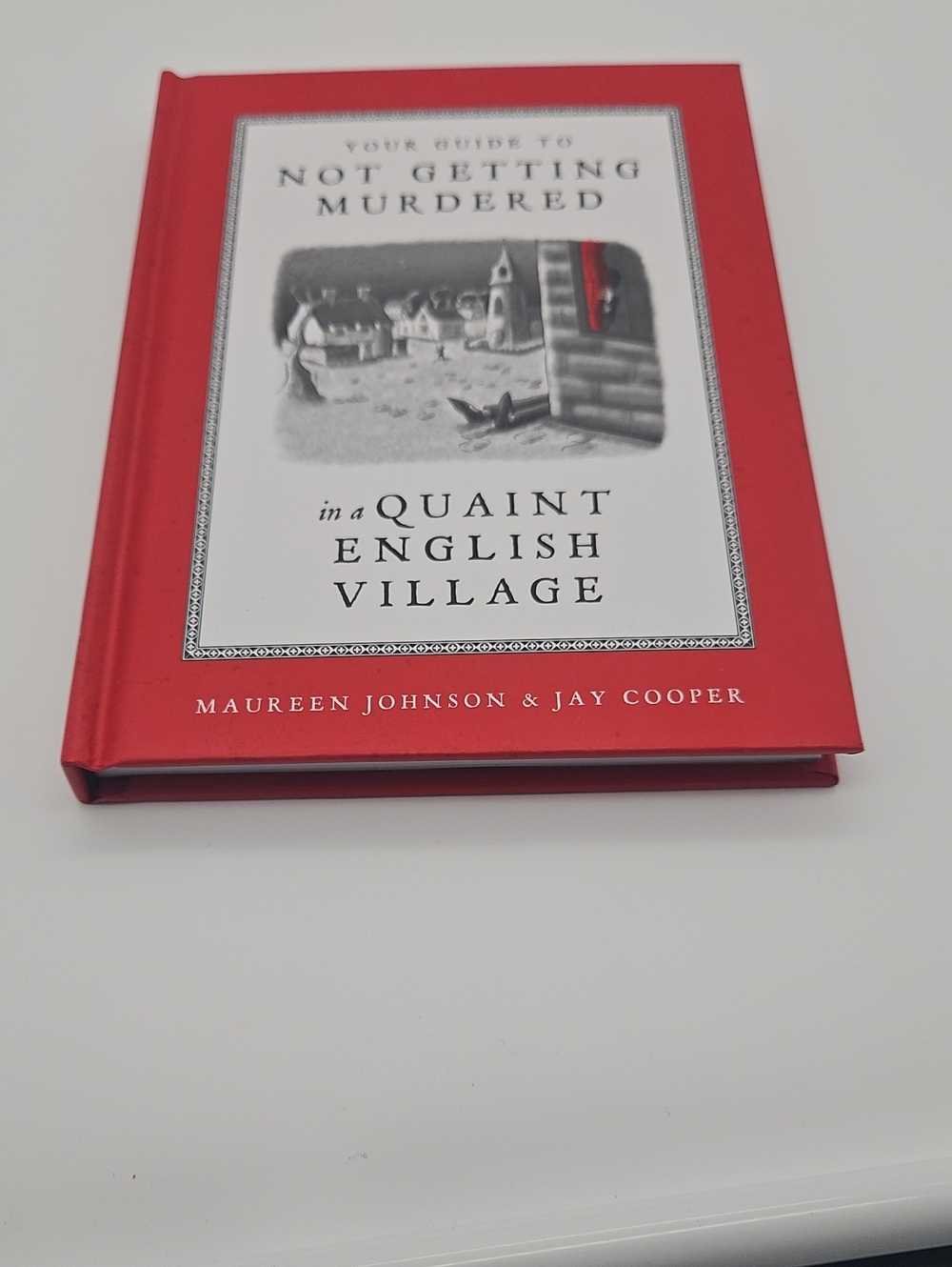 Not Getting Murdered in a Quaint English Village - Red Hardcover by